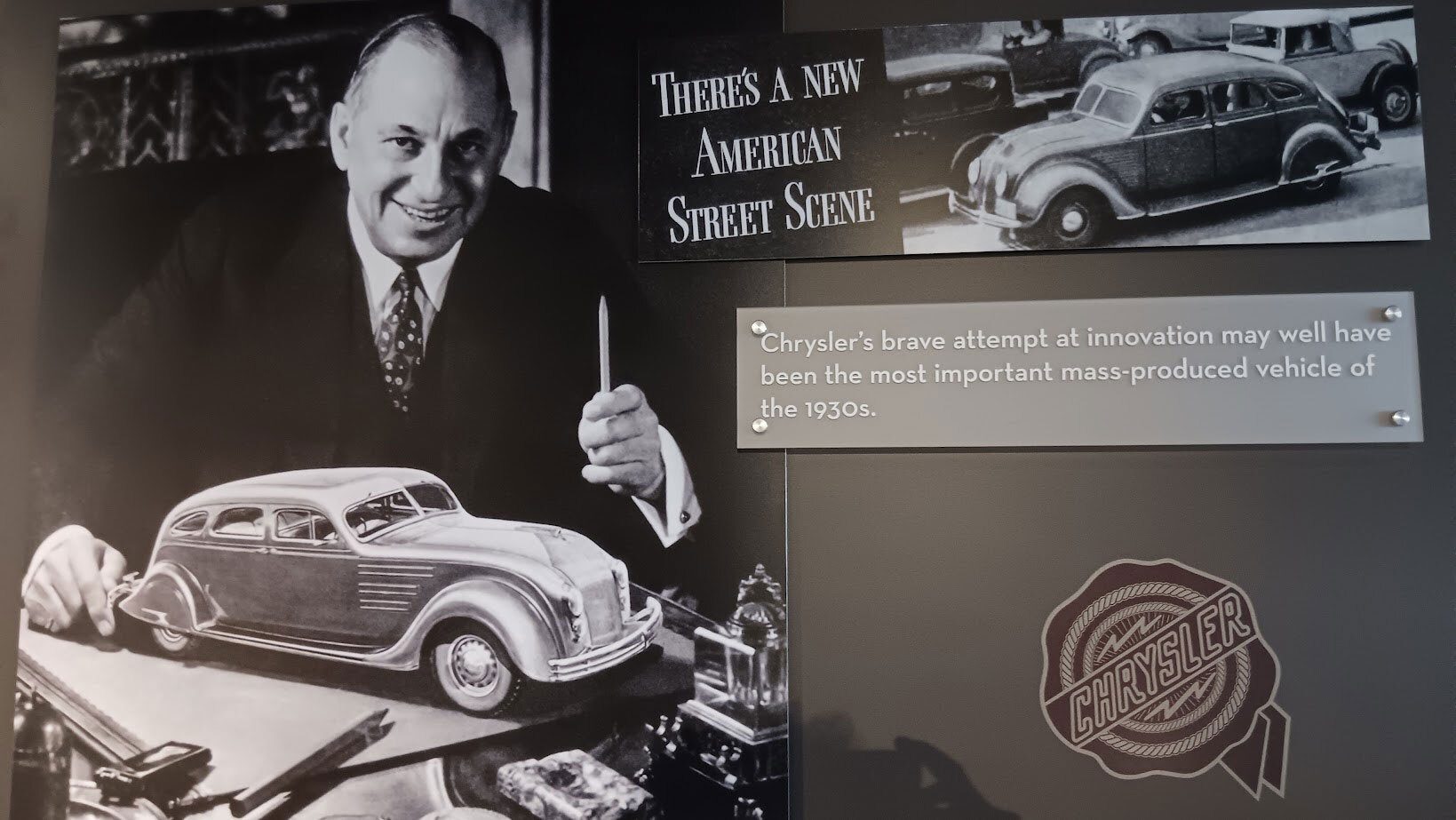 Black and white photo of a man with a Chrysler Airflow model car, text on innovation, and vintage cars.