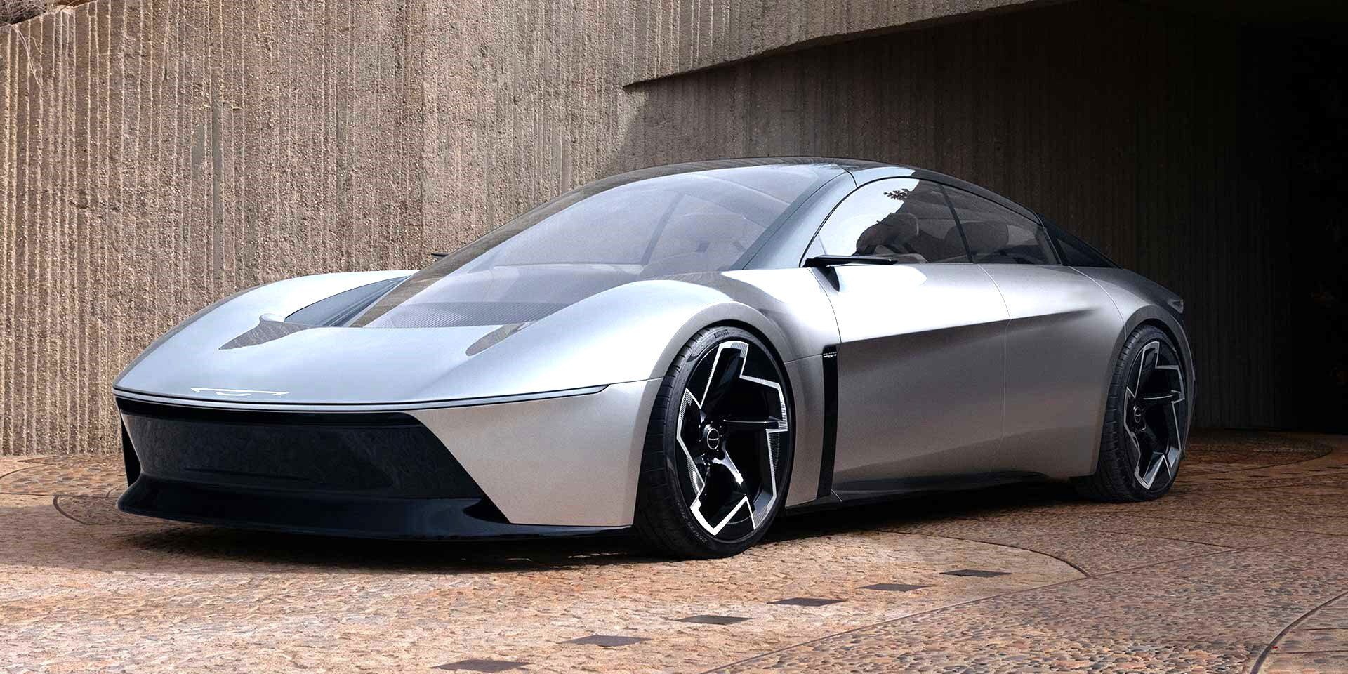 A sleek, futuristic silver car with a panoramic roof parked in front of a textured wall.