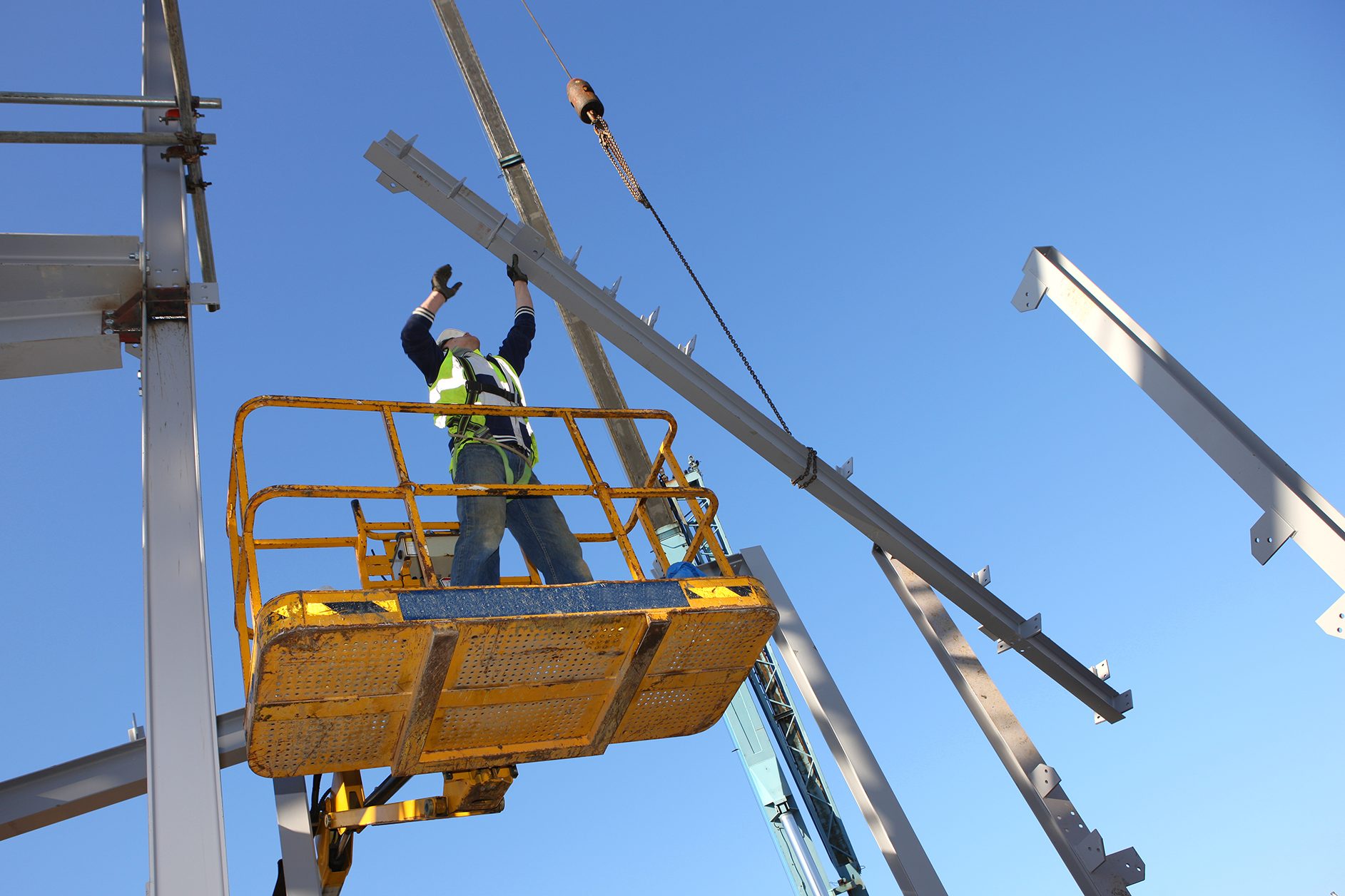 Hard hat, Construction worker, Sky, Tradesman, Workwear, Steelworker, Building