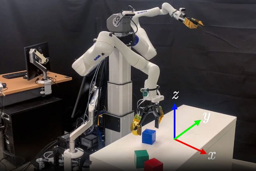 White robot arm manipulating colored blocks, with a coordinate system shown.