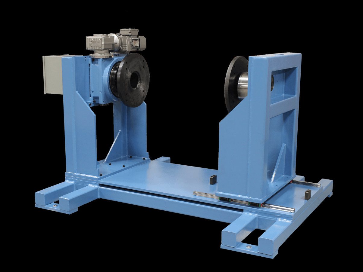 Blue industrial balancing machine with a motor, gearboxes, and flanges, against a black background.