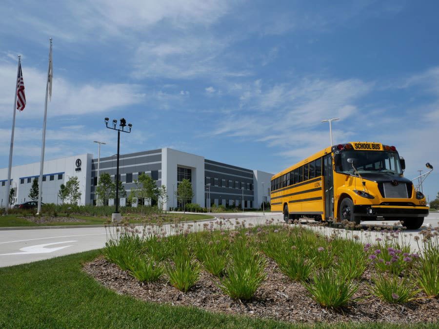 Motor vehicle, Sky, Bus, Cloud, Plant, Flag, Tire, Asphalt, Rolling