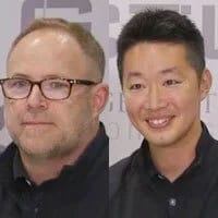 Two men: one white with glasses, one Asian smiling.