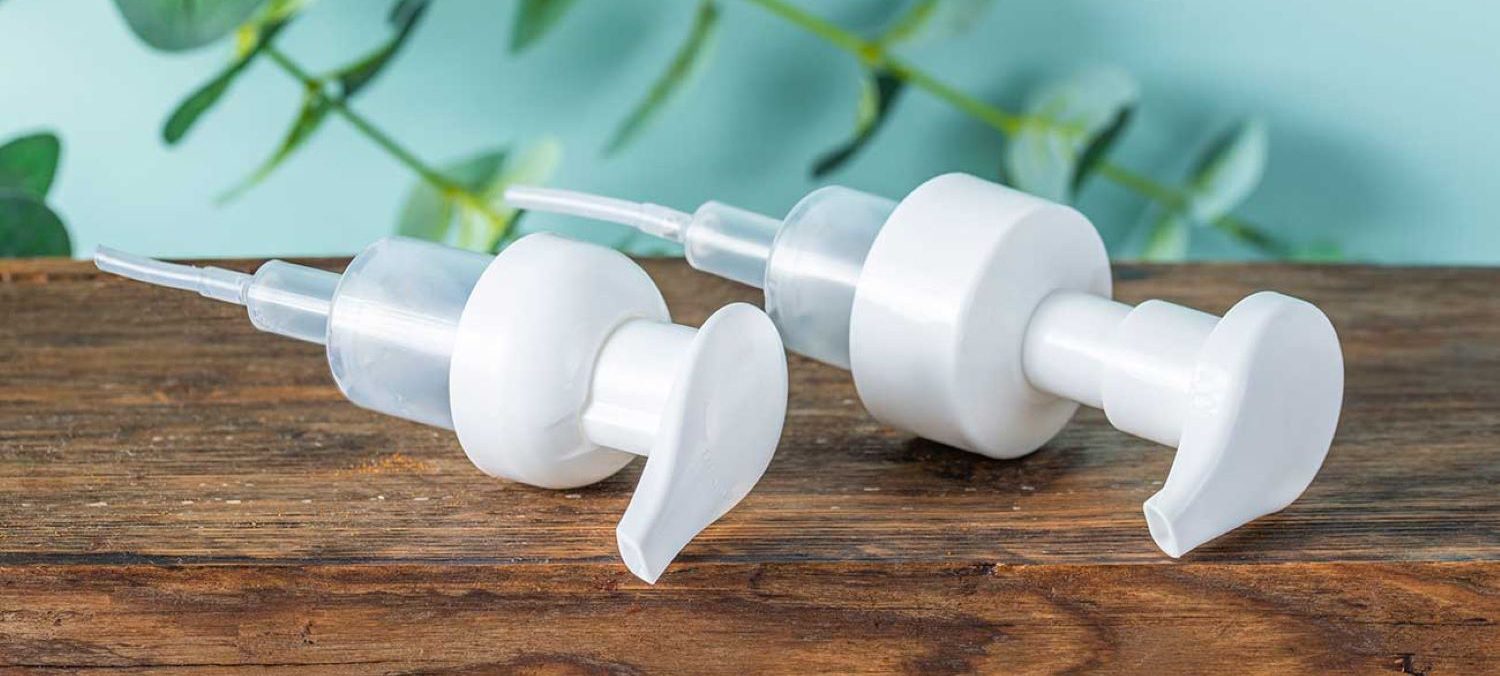 Pair of dispensers laying on wooden table