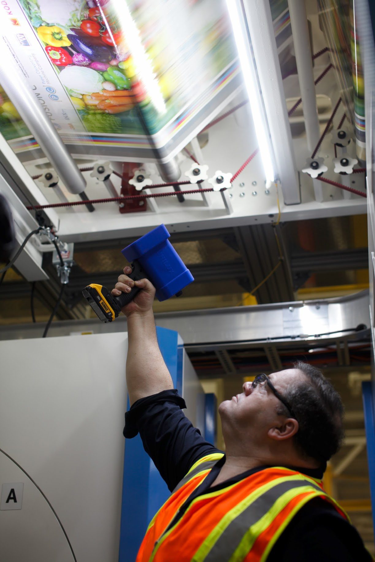 Employee using a handheld inspection strobe.