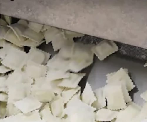 Baked goods going through cryogenic machinery