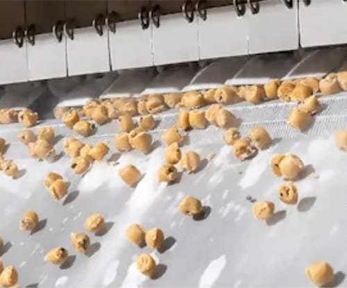 Baked goods going through cryogenic machinery