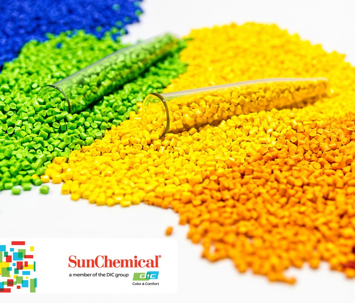 Colorful blue, green, yellow, and orange plastic pellets with two test tubes.