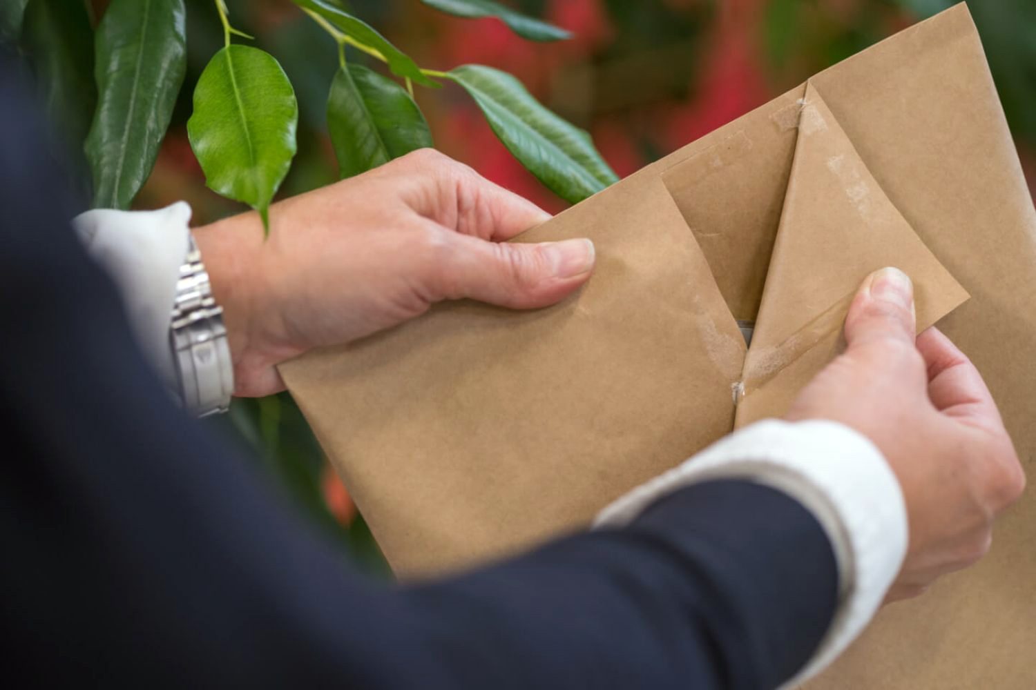 Pair of hands opening a mailer
