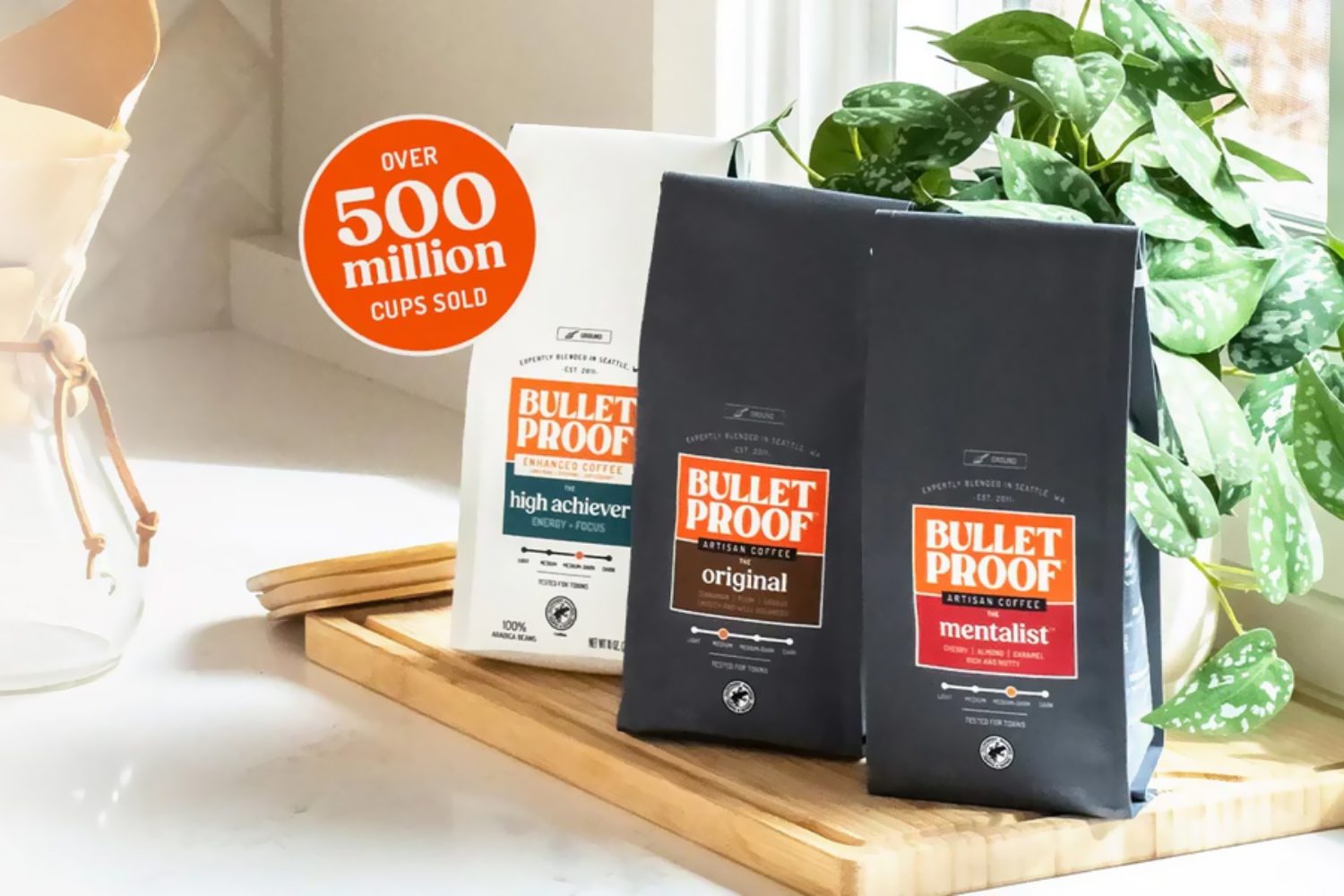 Bulletproof coffee packages with overlaid text “Over 500 million cups sold”