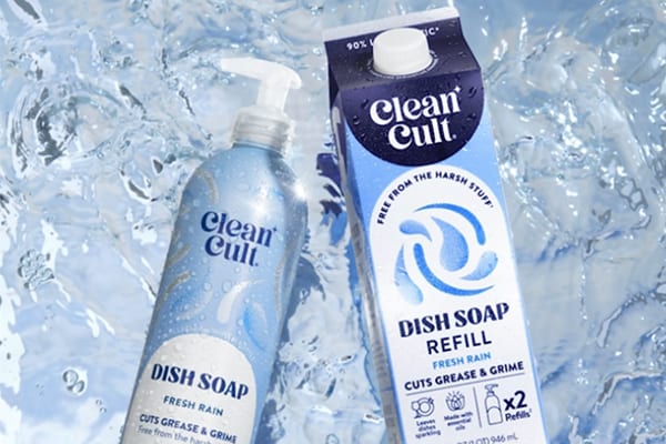 Clean Cult dish soap bottle and refill carton in Fresh Rain scent, surrounded by a splash of water.