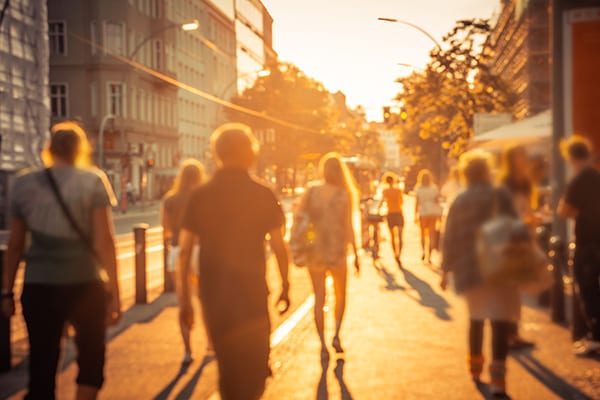 City street with hot sun and pedestrians