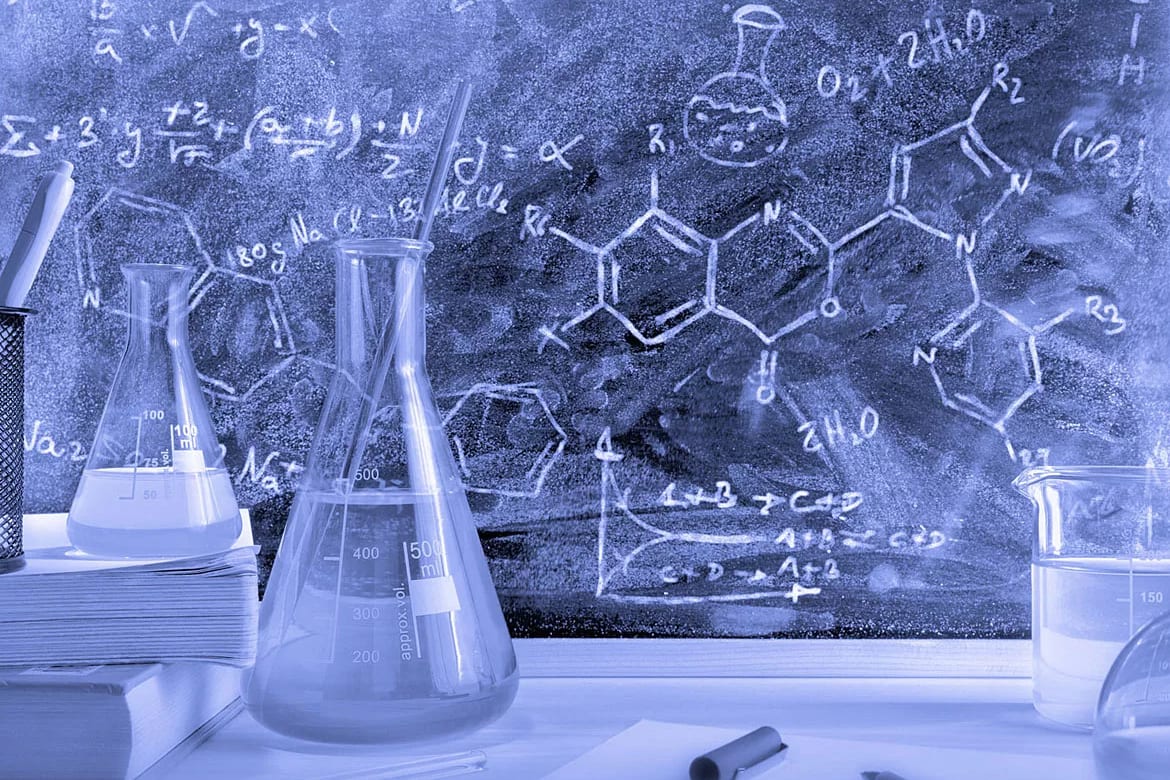 Blue-toned lab scene: flasks, beakers, and chemical formulas/math equations on a chalkboard.