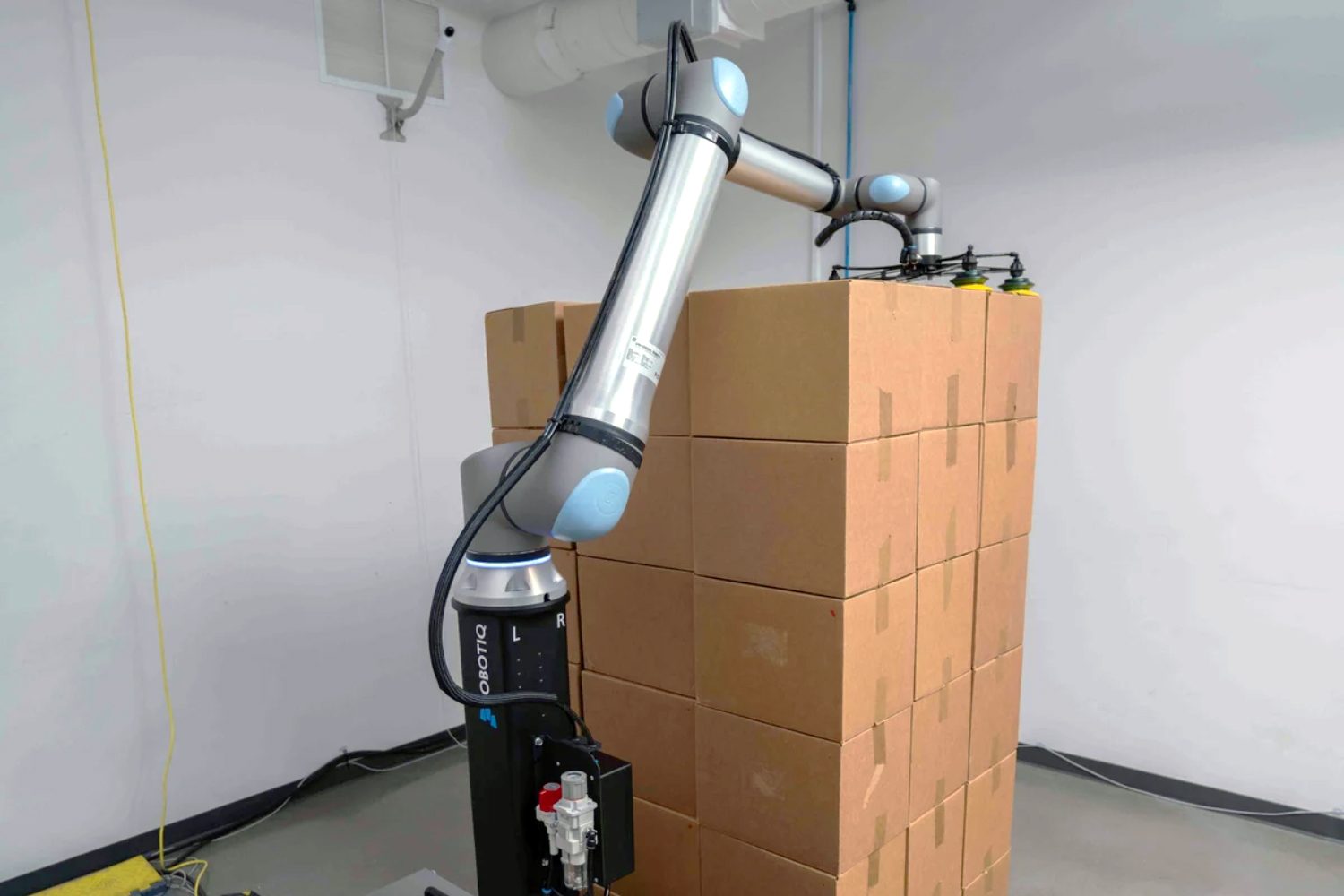 Robotiq palletizer placing cardboard boxes in stacks