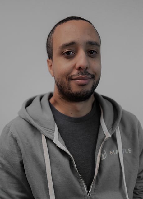 Smiling man in gray hoodie with 'MATLE' logo.