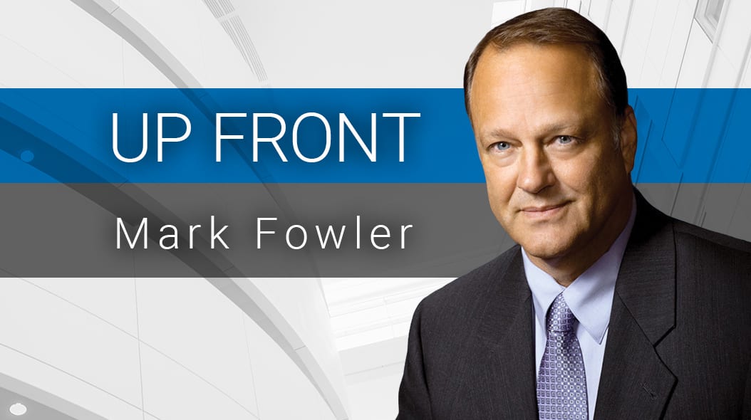 Mark Fowler, a man in a suit, smiles next to "UP FRONT" text on a blue and gray background.