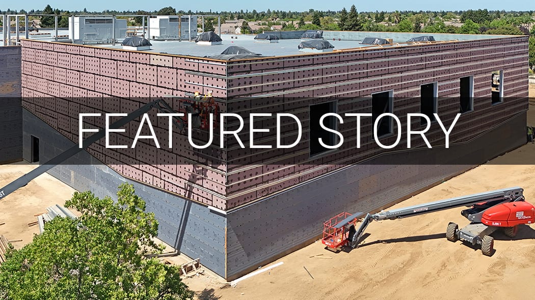 Building under construction with insulation and equipment. Text overlay: 'FEATURED STORY'.