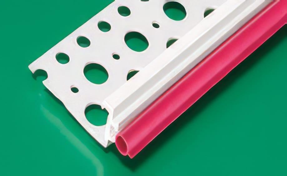 White perforated strip attached to a pink tube on a green background.