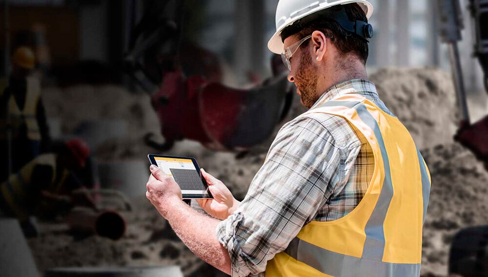 Construction worker looking at tablet