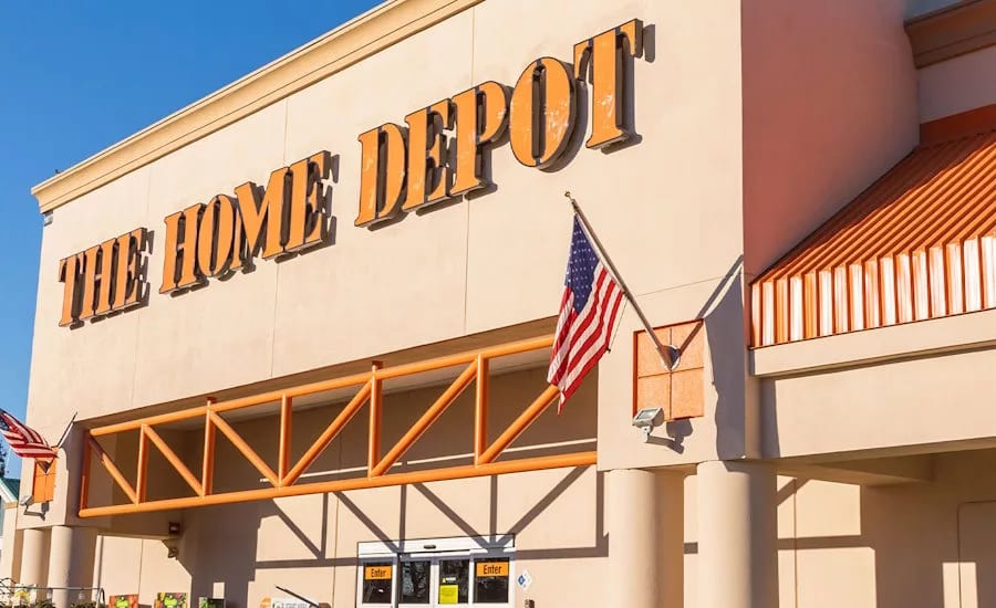 The Home Depot store facade with its prominent sign and an American flag proudly displayed.