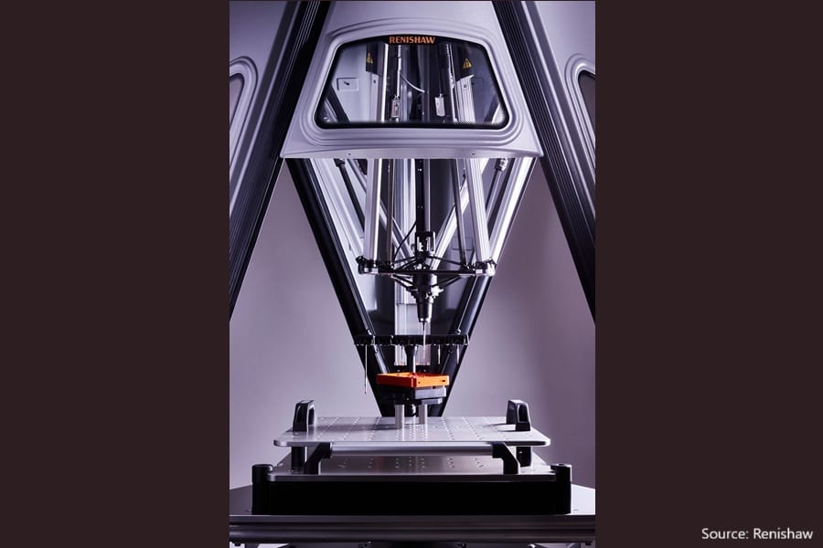 A Renishaw precision machine uses a probe to inspect an orange part on a platform.