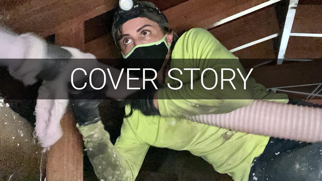 Woman in headlamp and mask installing insulation in an attic. Text: COVER STORY.
