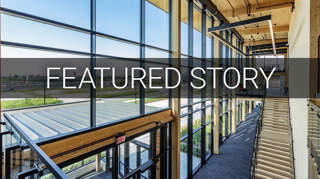 "FEATURED STORY" text on a modern building interior with wood, glass, and stairs.