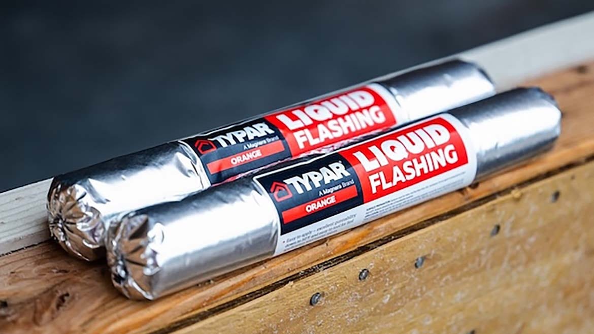 Two tubes of TYPAR Liquid Flashing rest on a wooden beam.
