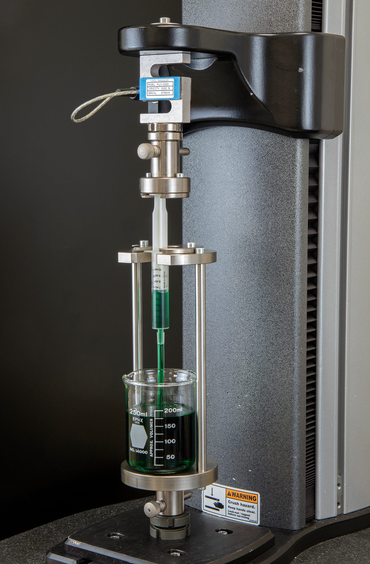 Starrett FMS Series test frame measuring the force to draw fluid in and out of a syringe. This application uses Starrett L2Plus software to capture peak and average load. Scientific instrument, Liquid, Product, Fluid