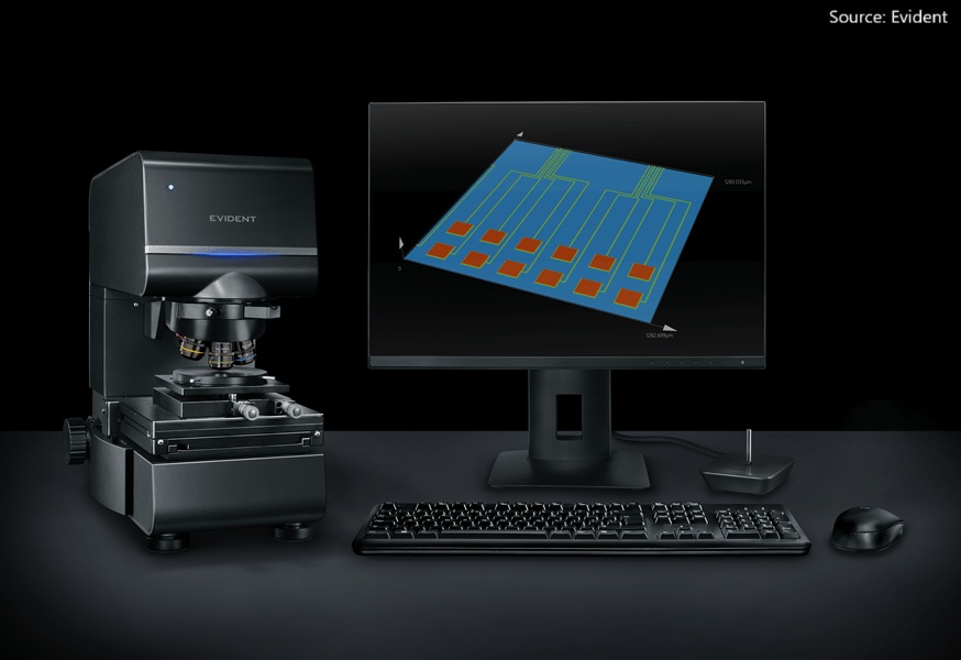 Evident microscope, monitor displaying a 3D chip model, keyboard, and mouse on a dark surface.