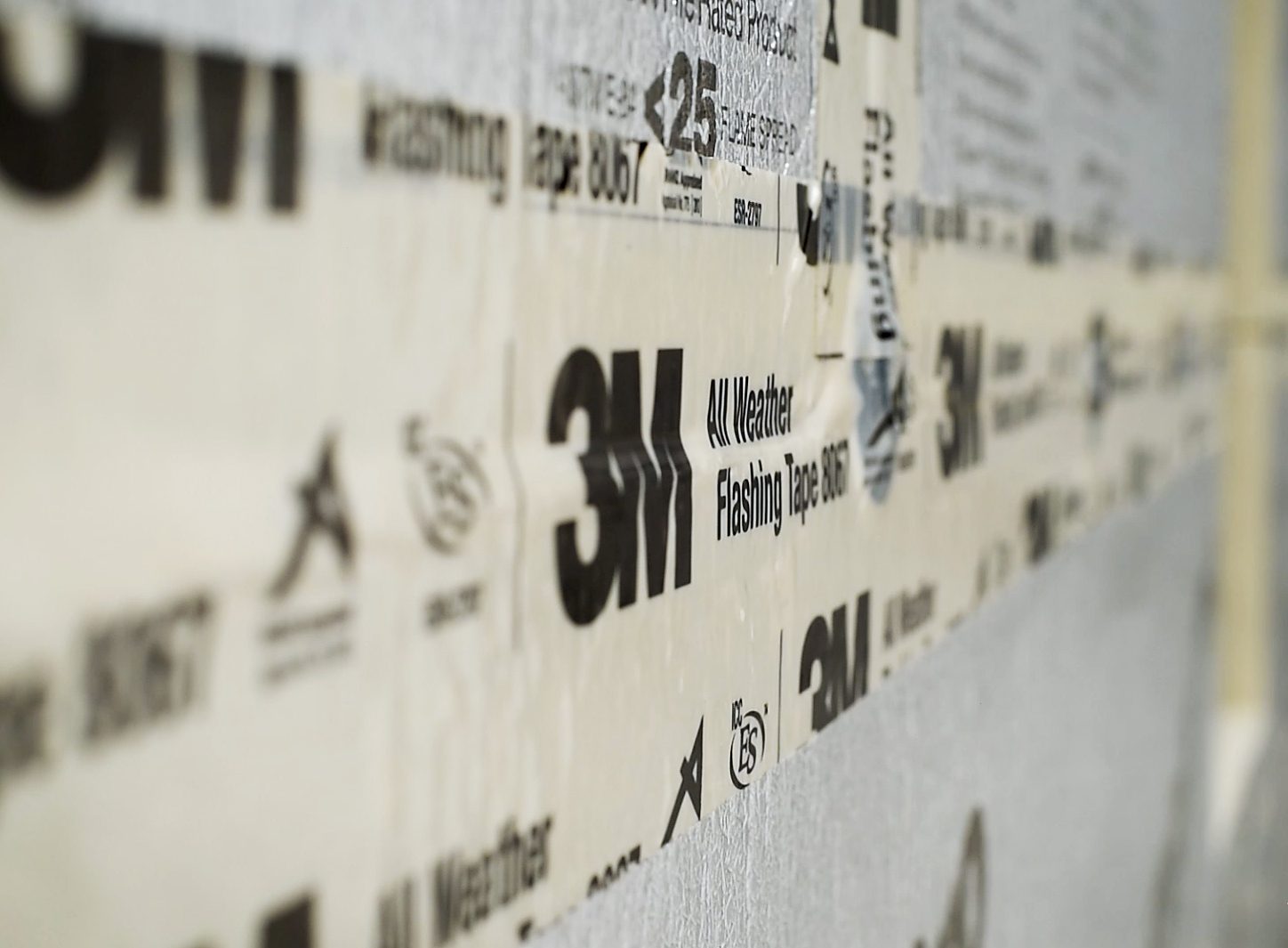 Close-up of 3M All Weather Flashing Tape 8067 applied to a wall.