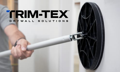 Person using a TRIM-TEX pole sander for drywall on a white wall.