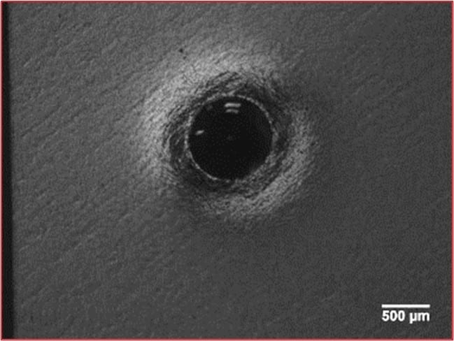 Visible material deformation around a hardness indent