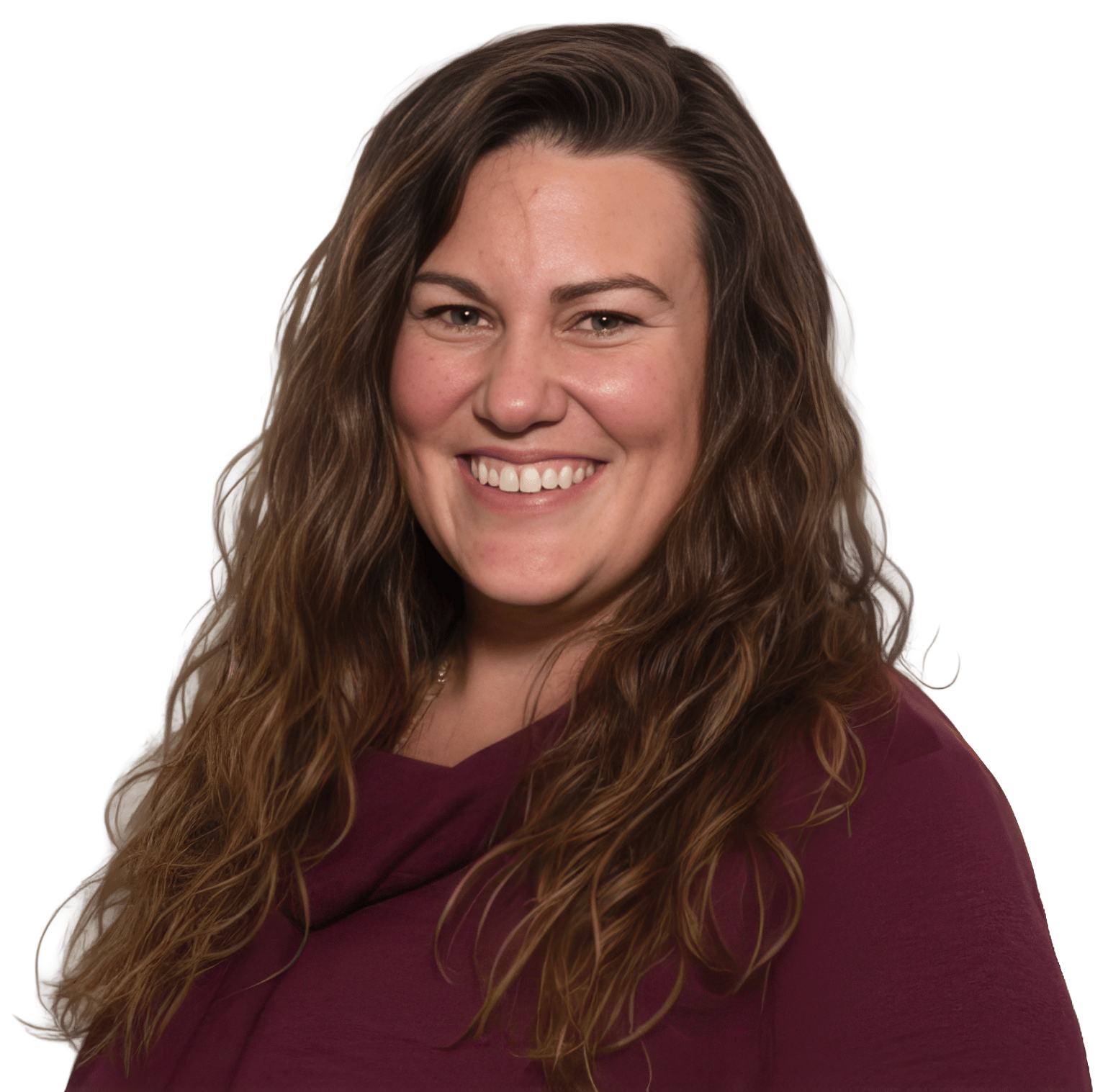 A smiling woman with long brown wavy hair wearing a maroon top against a green background.