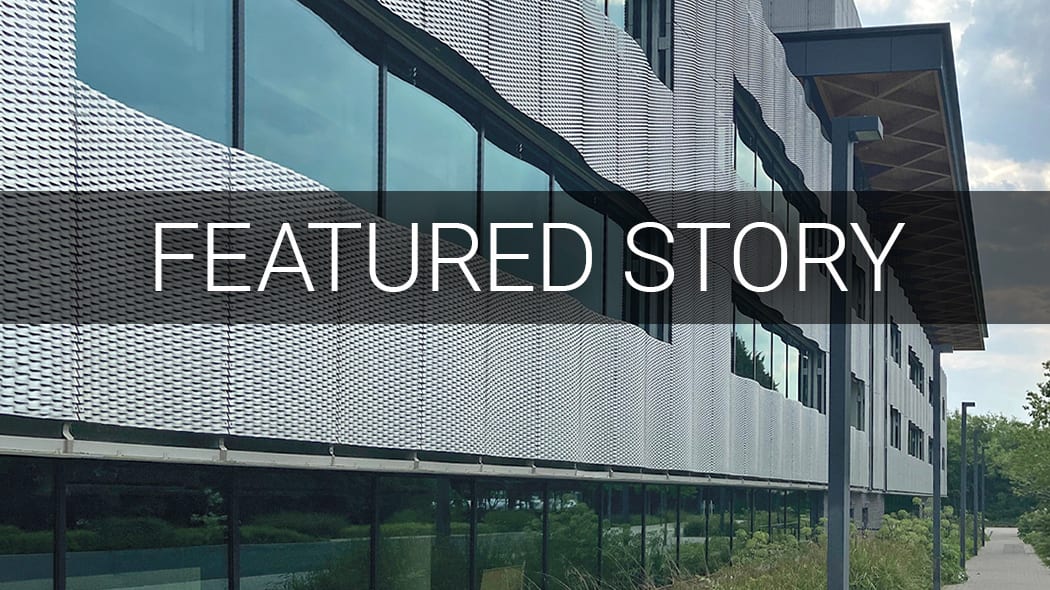 A modern building with a perforated metal facade and large windows, overlaid with "FEATURED STORY" text.