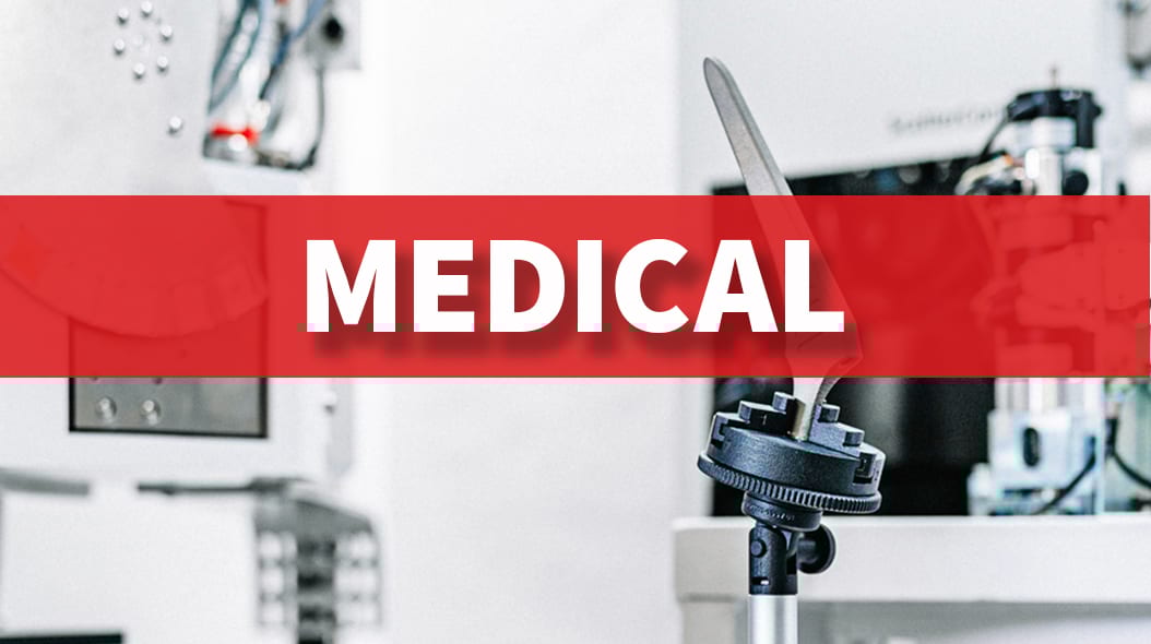 Red banner with 'MEDICAL' in white over blurry background of laboratory or industrial equipment.