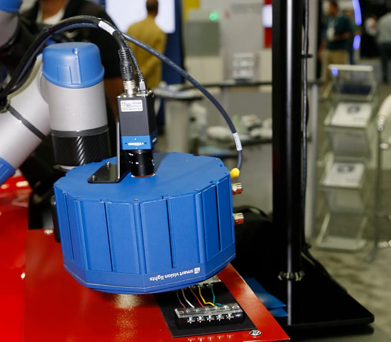 : A multifunctional lighting unit attached to a machine vision camera performs an inspection during a tradeshow demonstration.