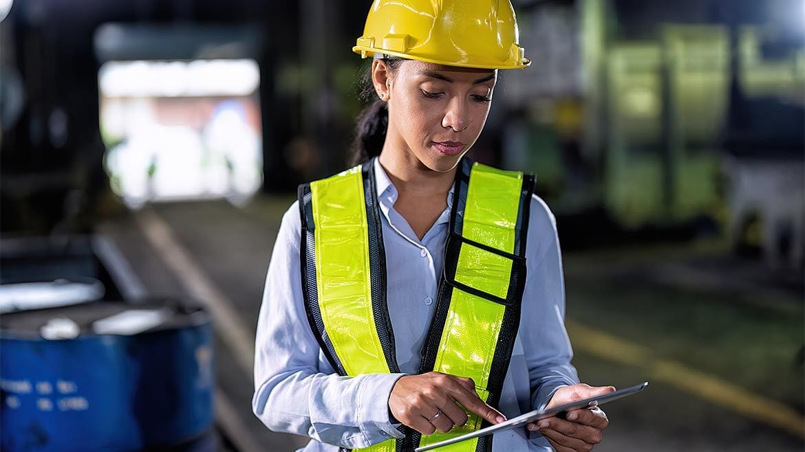 Worker with hard hat using tablet device