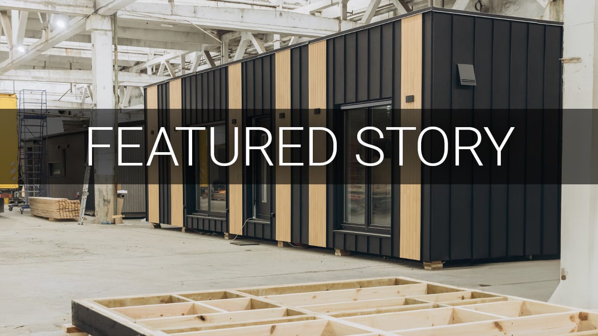 Modular homes under construction in a factory. Text: FEATURED STORY.