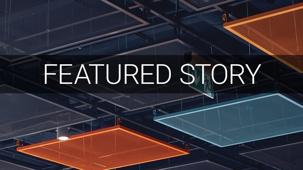 Text "FEATURED STORY" on dark banner, industrial ceiling with orange/blue panels, and exit sign.