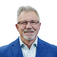 Smiling man with glasses, grey hair, and beard in a blue suit.