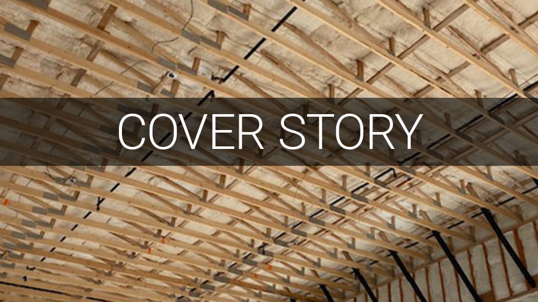 Ceiling with wooden trusses, insulation, and a "COVER STORY" banner.