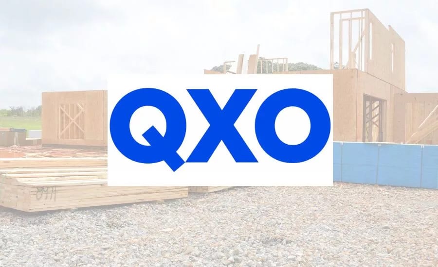 Blue QXO logo on white background over a faded construction site with wooden house framing.