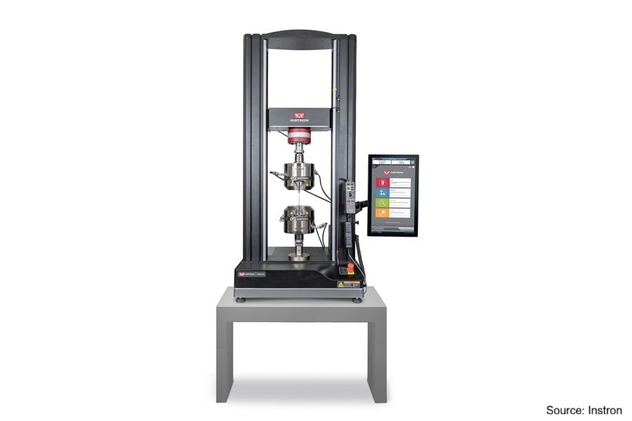Instron universal testing machine with a test sample and control screen.