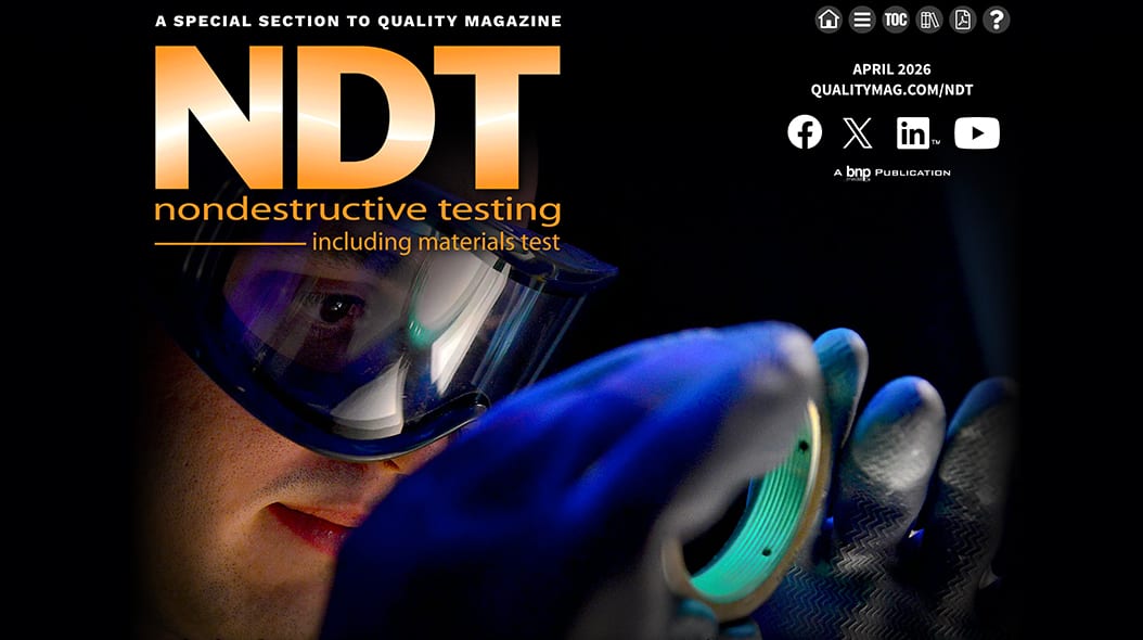 A technician wearing goggles and gloves inspects a glowing, circular component using nondestructive testing methods.