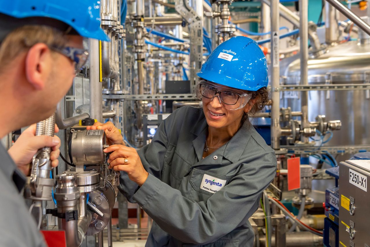 two Syngenta employees wearing PPE in a production facility