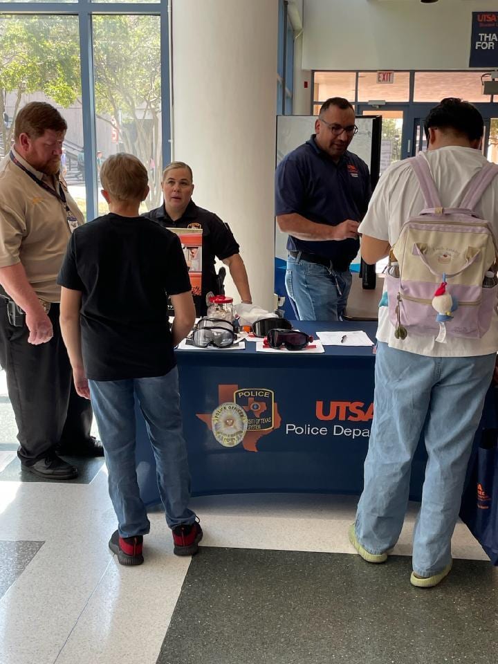 Campus staff discussing risky behaviors with students at table