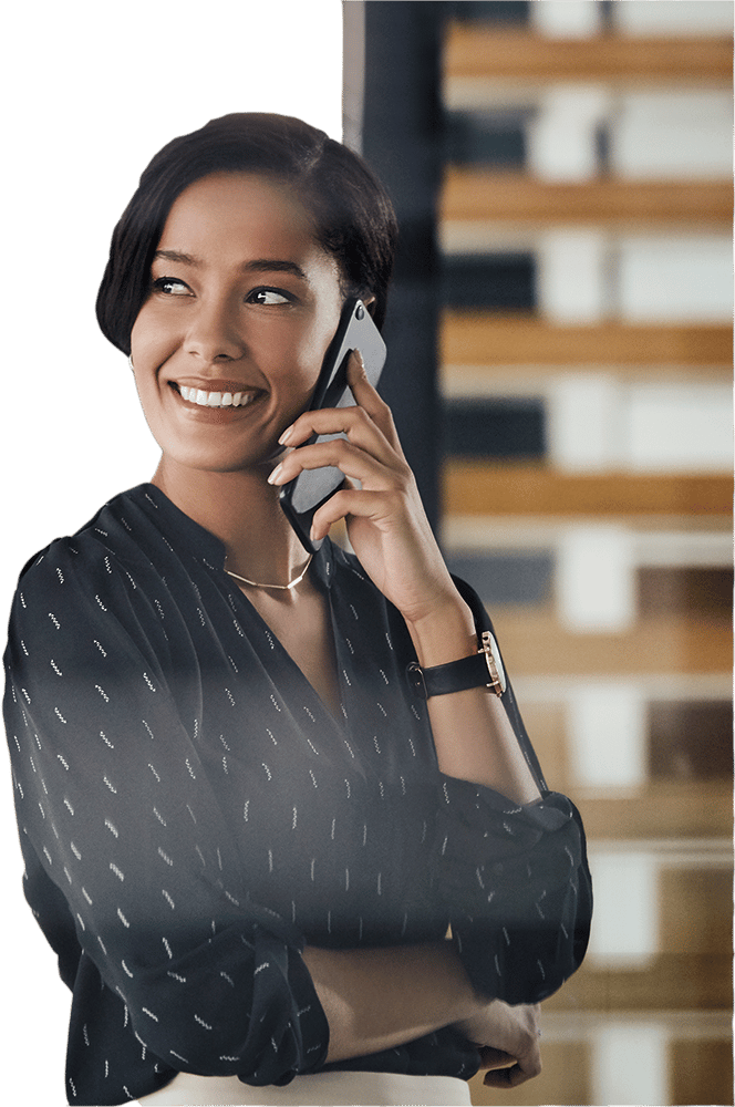 Smiling woman with short dark hair talking on a phone.