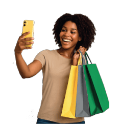 Smiling Black woman takes a selfie, holding shopping bags.