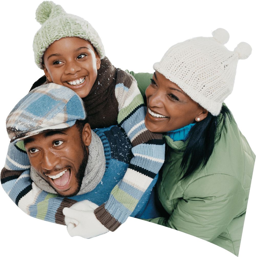 A smiling family of three, dressed in winter hats and sweaters, laughing and enjoying time together.